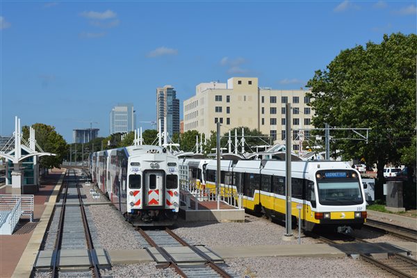 DART's Blue Line and the Trinity Rail Express wait outside of Dallas Union Station. Amtrak's track is just to the left. 